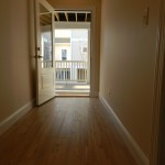 Hallway Access to Rear Deck on 1st Floor - hardwood floors in vacation rental home